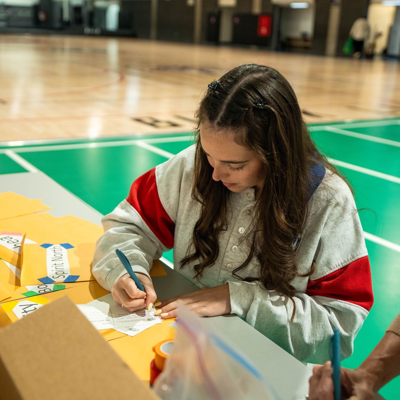 A young participant taking notes during the event